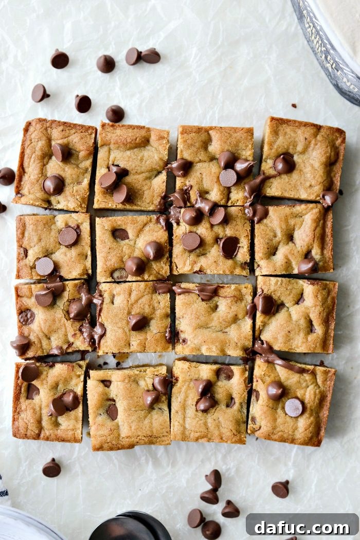 Golden Brown Butter Chocolate Chip Blondies 19 Fully cooled Brown Butter Chocolate Chip Blondies cut into perfect squares on a cutting board.