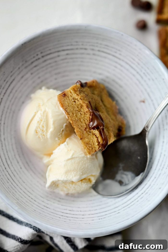 Golden Brown Butter Chocolate Chip Blondies 20 A brown butter chocolate chip blondie served warm with a scoop of vanilla ice cream, ready to be enjoyed.