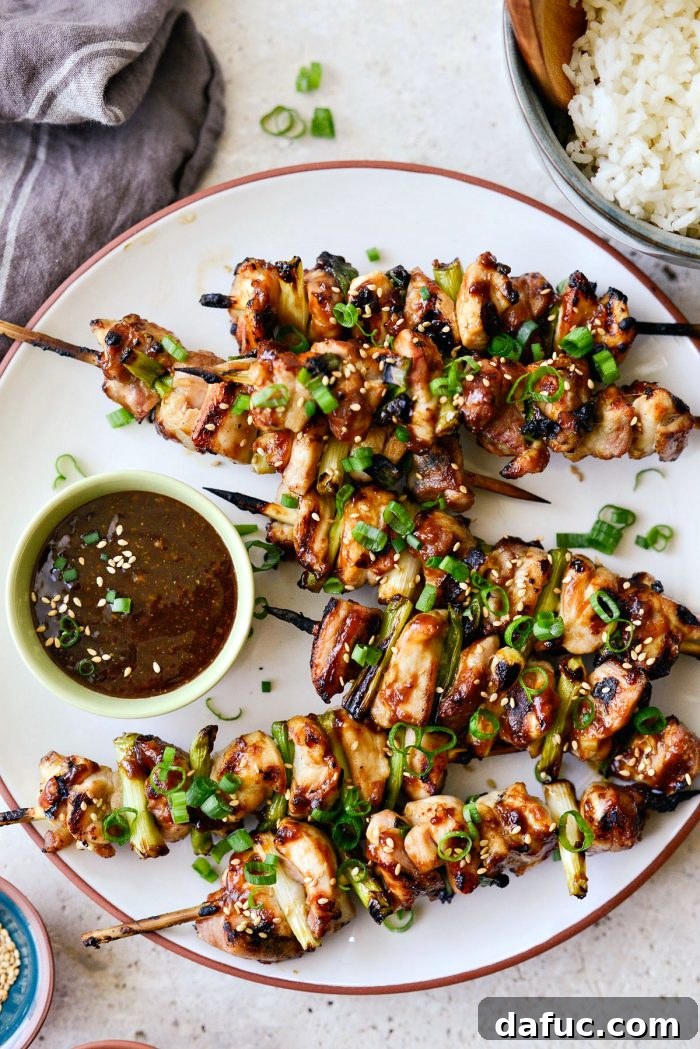Grilled Chicken Yakitori skewers hot off the grill, glistening with savory sauce.