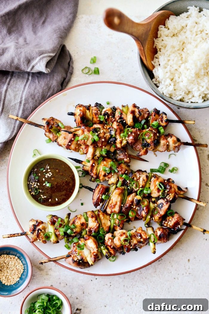 Cooked Chicken Yakitori skewers removed from the grill and placed on a platter.
