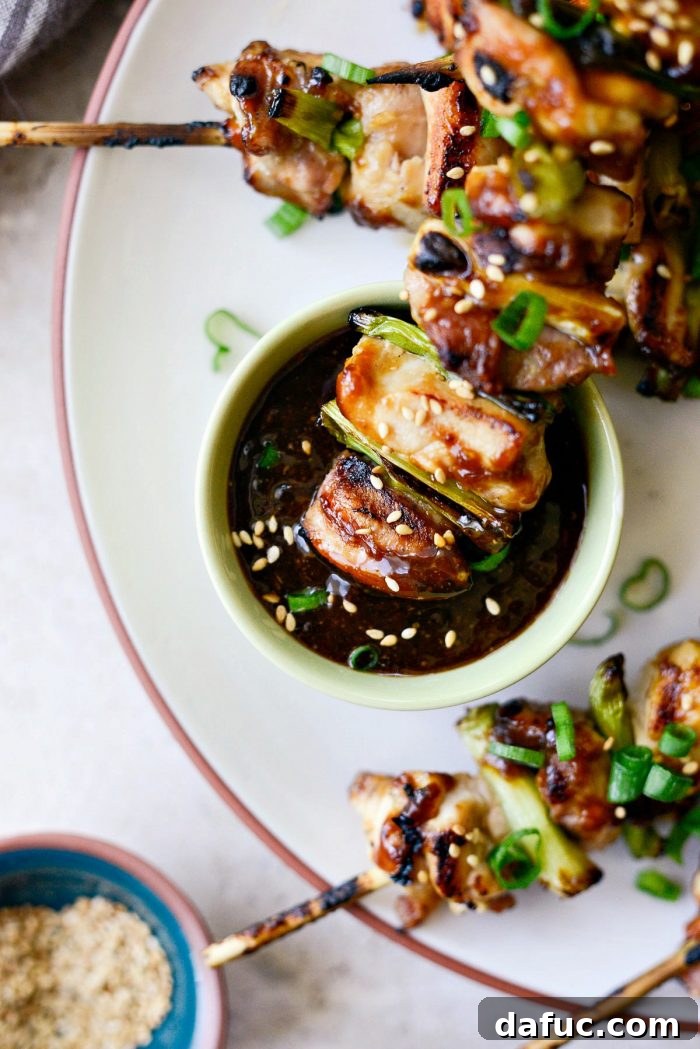 A final shot of garnished Chicken Yakitori skewers on a serving board.