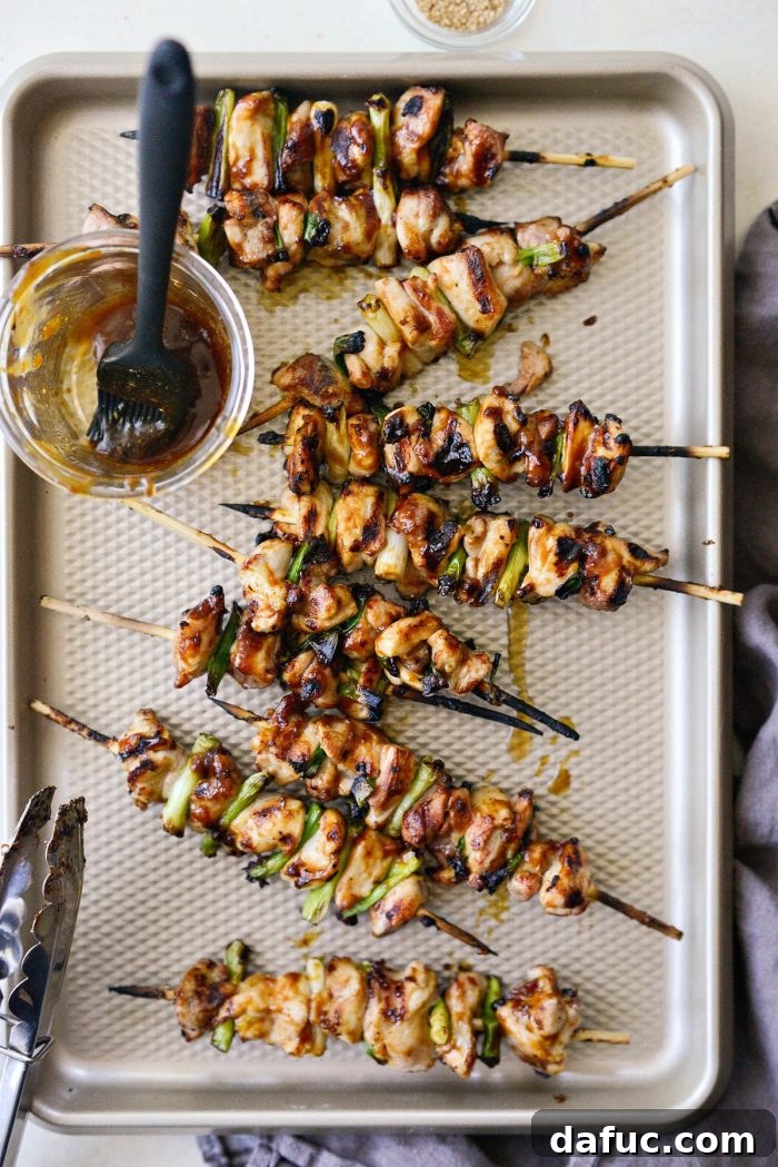 Fully cooked Chicken Yakitori skewers, glistening with caramelized sauce on the grill.