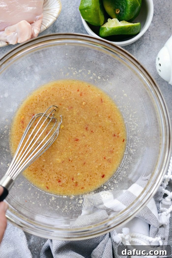Vibrant Grilled Thai Chicken Salad 7 Whisked Thai chicken marinade in a bowl, showing a smooth, cohesive mixture.