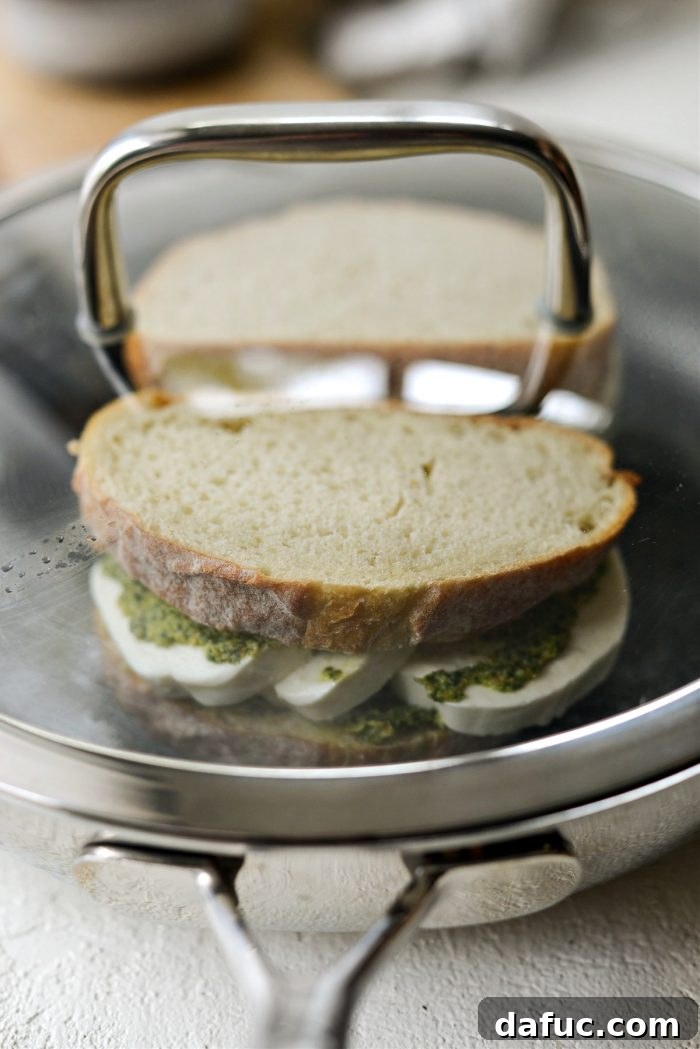 add sandwiches and cover with a lid to steam and help cheese soften quickly