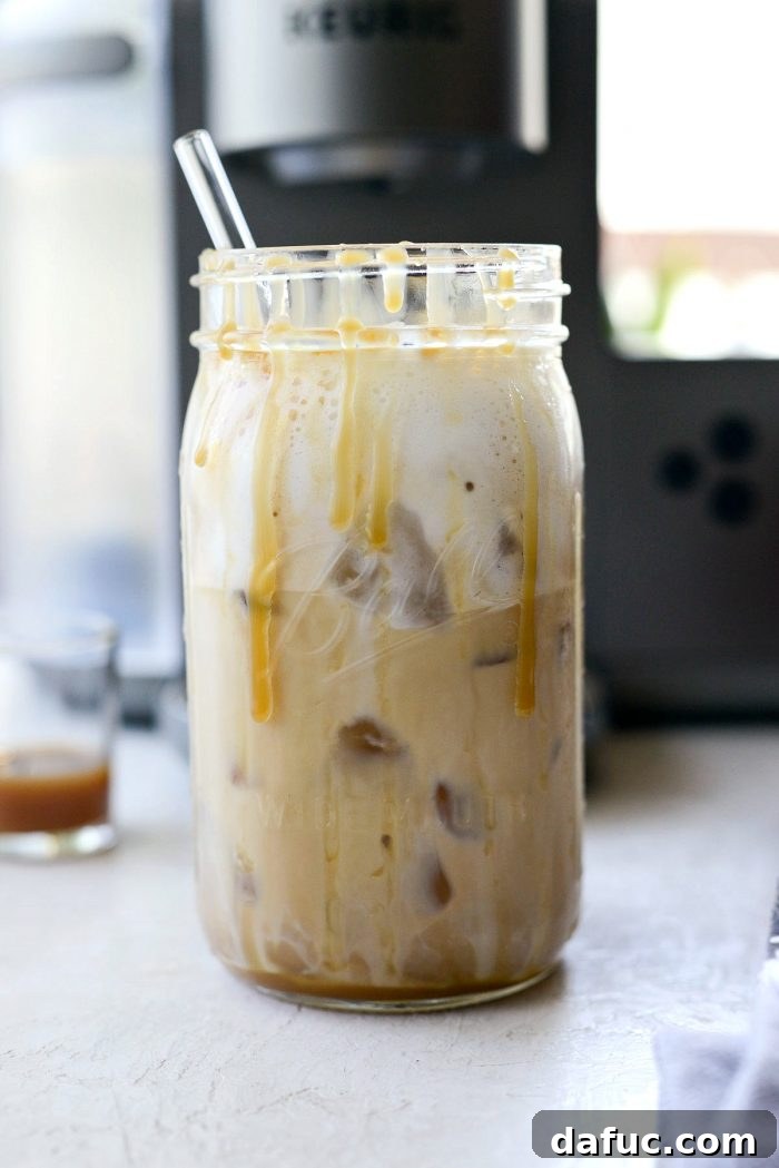 Velvet Caramel Vanilla Chill 14 Inserting a straw into the finished Iced Caramel Vanilla Latte.