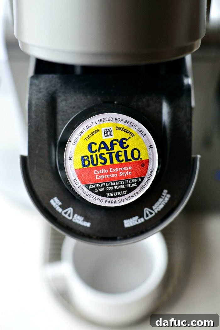 Velvet Caramel Vanilla Chill 8 An espresso K-cup placed inside a Keurig coffee machine.