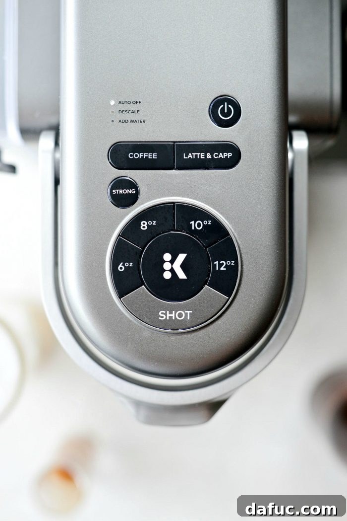 Velvet Caramel Vanilla Chill 9 Pressing the start button on a Keurig coffee maker.