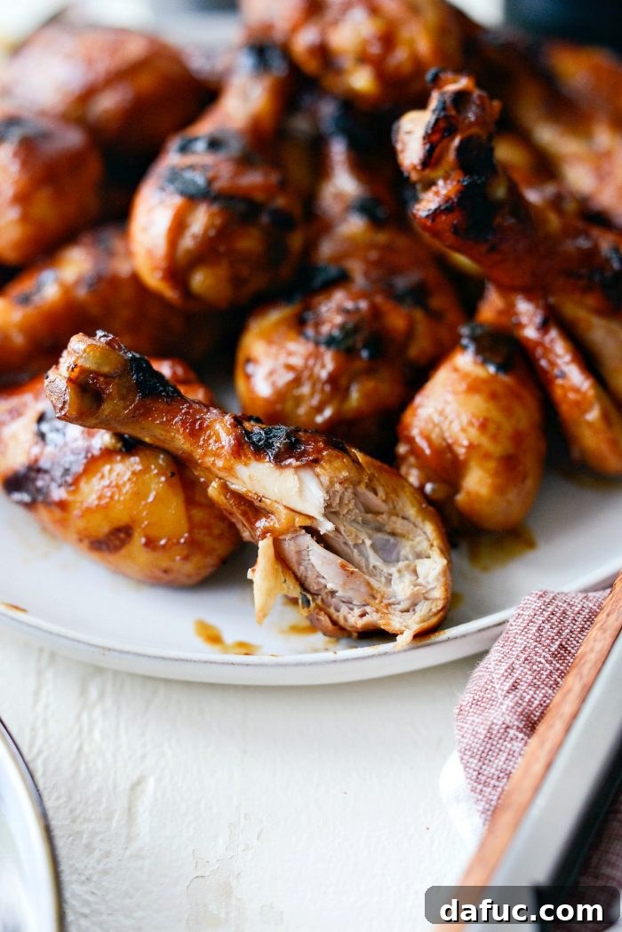 Sticky Sweet BBQ Drumsticks 16 A close-up shot of a single easy BBQ chicken drumstick, showing a delicious bite taken, emphasizing the tenderness and juicy interior.