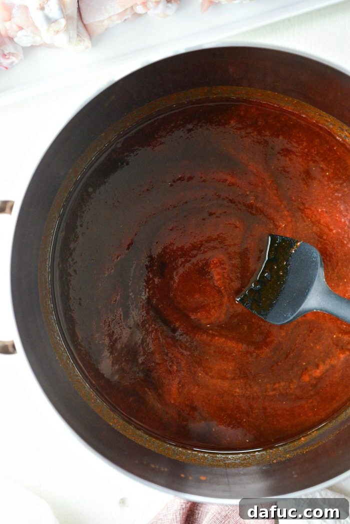 Sticky Sweet BBQ Drumsticks 5 Homemade barbecue sauce bubbling gently in a large pot, ready for the chicken drumsticks to be added.