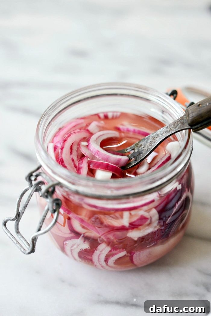 Zesty Quick Pickled Red Onions 11 A forkful of brightly colored quick pickled red onions, ready to be served