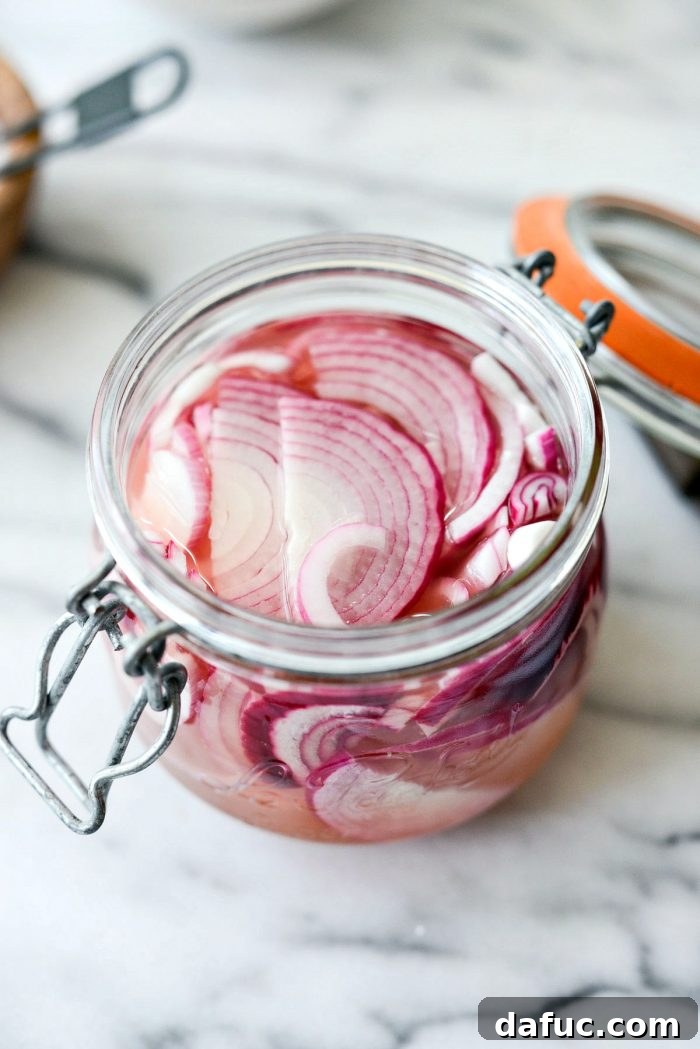 Zesty Quick Pickled Red Onions 9 Pickled red onions transforming their color to a vibrant pink in the jar