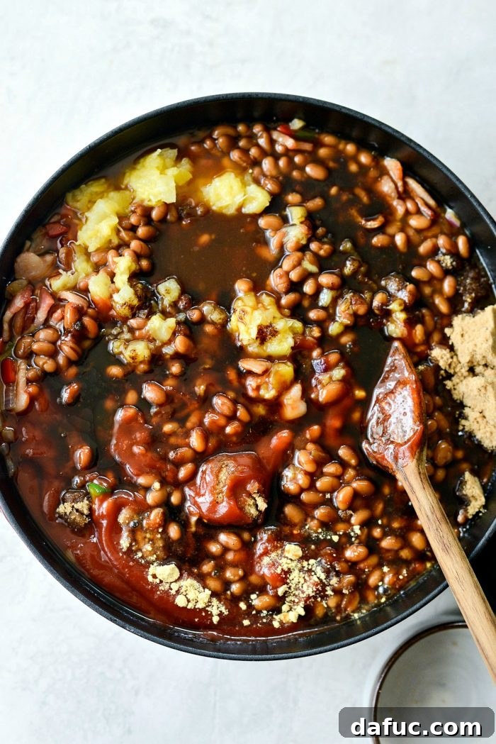 One Pot Wonder Baked Beans 11 a close-up shot of the baked beans mixture being stirred in the pot, showing the thorough combination of ingredients