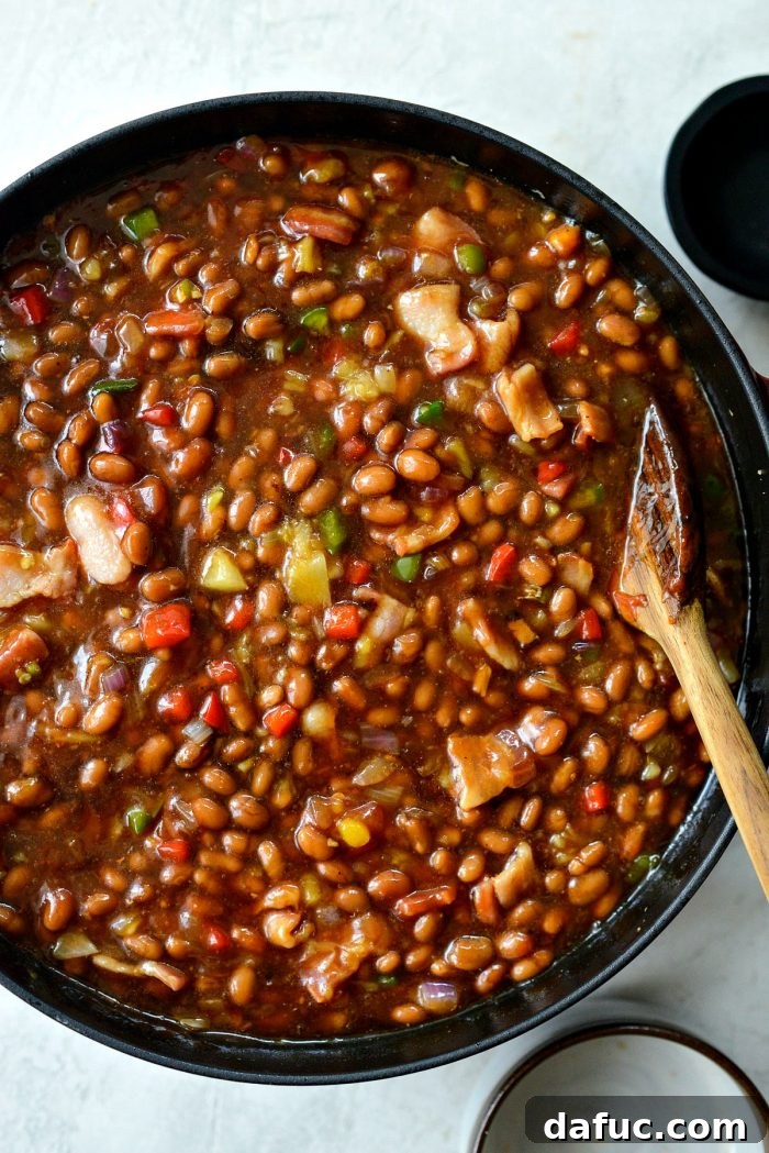 One Pot Wonder Baked Beans 12 the pot of wicked baked beans baking uncovered in the oven, showing gentle bubbling