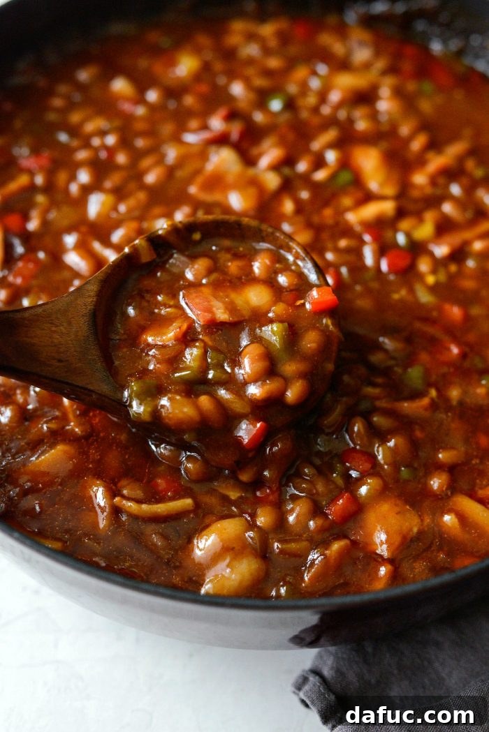 One Pot Wonder Baked Beans 15 a scoop of one pot wicked baked beans on a plate, showcasing the hearty texture and rich sauce
