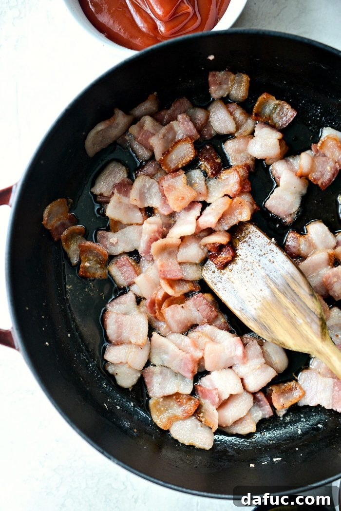 One Pot Wonder Baked Beans 6 crispy bacon sizzling in a skillet, showcasing its golden-brown texture