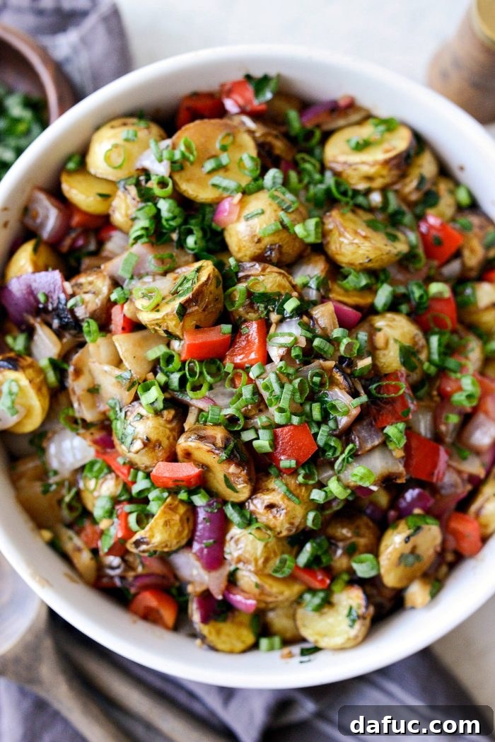 Tuck's potato salad in a cream bowl, garnished with fresh herbs.