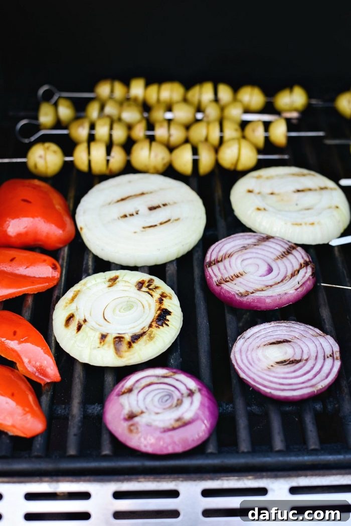 Close-up of grilled onions and bell peppers showcasing perfect grill marks.