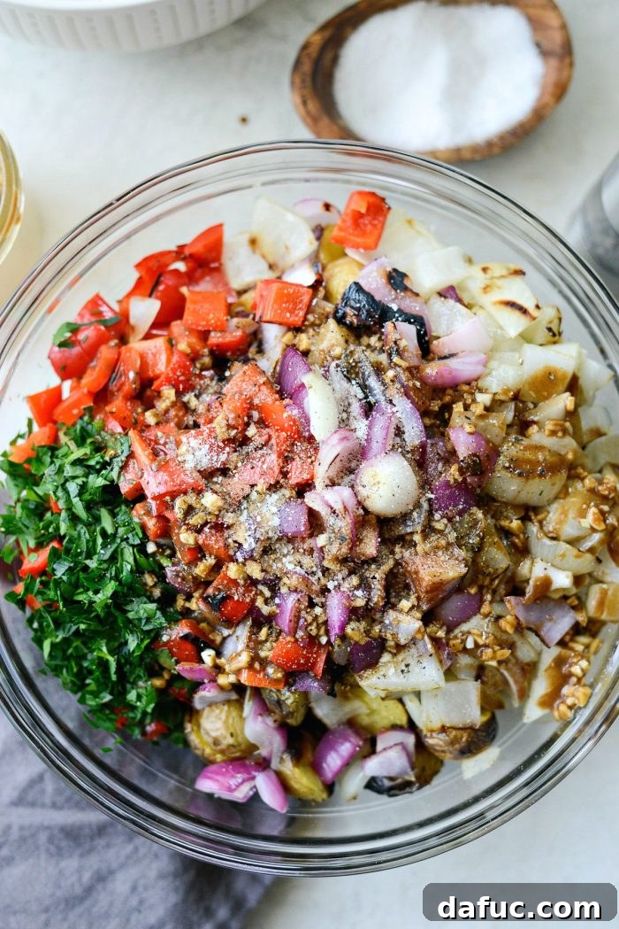 Seasoning the potato salad generously with kosher salt and black pepper.