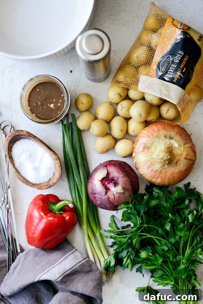 Assortment of fresh ingredients for Tuck's potato salad, including potatoes, peppers, and onions.