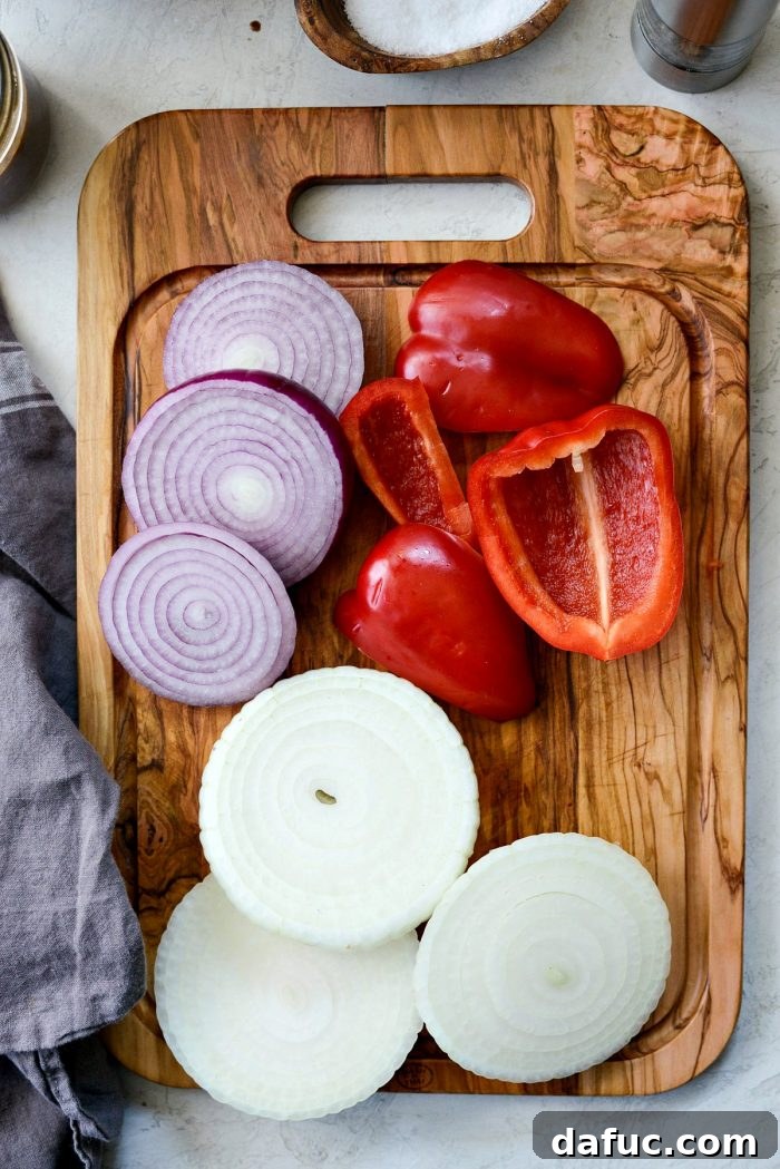 Sliced red bell pepper, red onion, and Vidalia onion prepared for grilling.