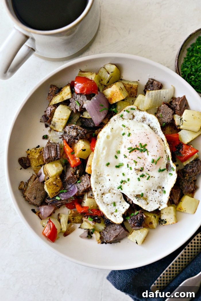 Smoked Brisket Breakfast Hash 10 A creamy bowl filled with Smoked Brisket Breakfast Hash, beautifully topped with a fried egg and fresh chives.
