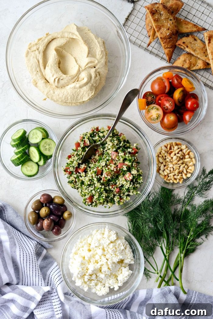 Fresh ingredients laid out for making the 7-Layer Loaded Hummus Dip