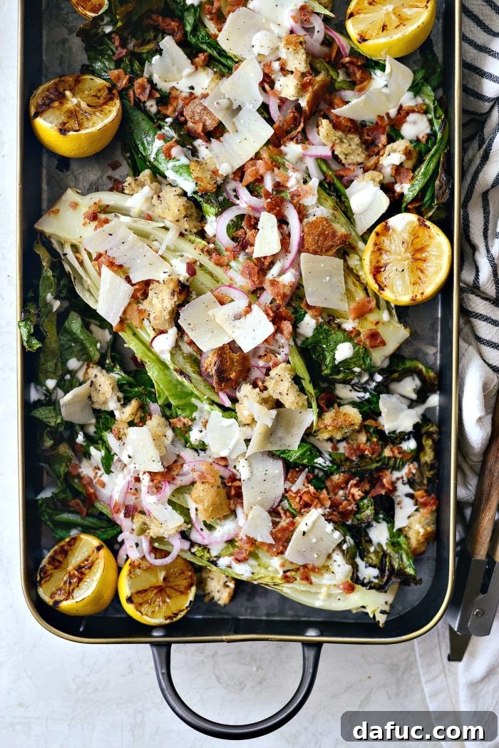 Close-up of a single serving of Grilled Romaine Salad, showcasing the abundant toppings and dressing