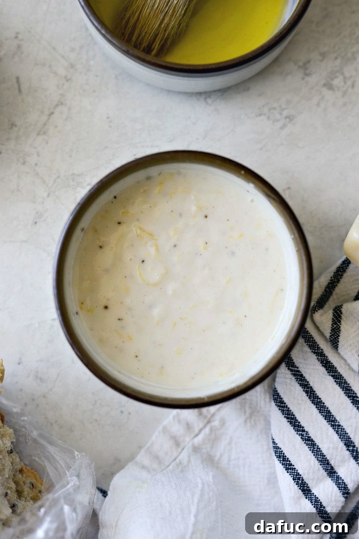 Finished creamy lemon dressing in a rustic brown-rimmed bowl