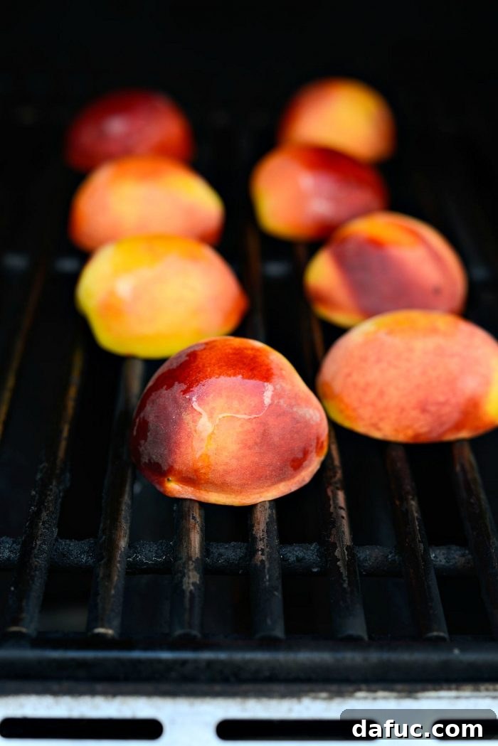 Peaches grilling on a hot barbecue, showing grill marks