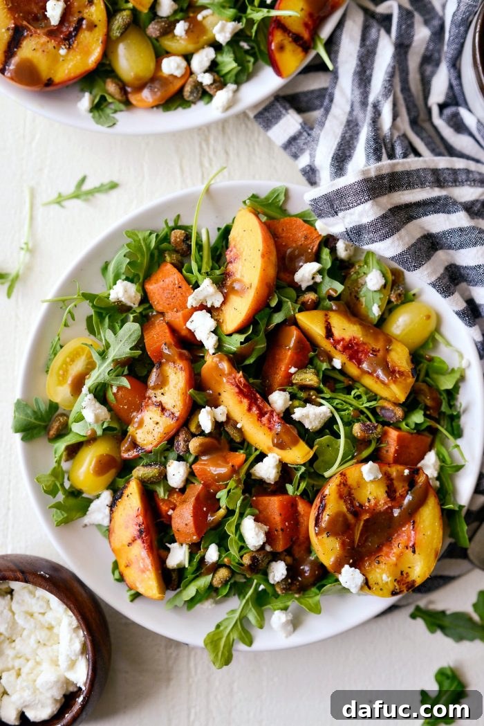 Sweet and Savory Peach Sweet Potato Arugula Salad 9 A freshly assembled Grilled Peach Sweet Potato Arugula Salad on a plate