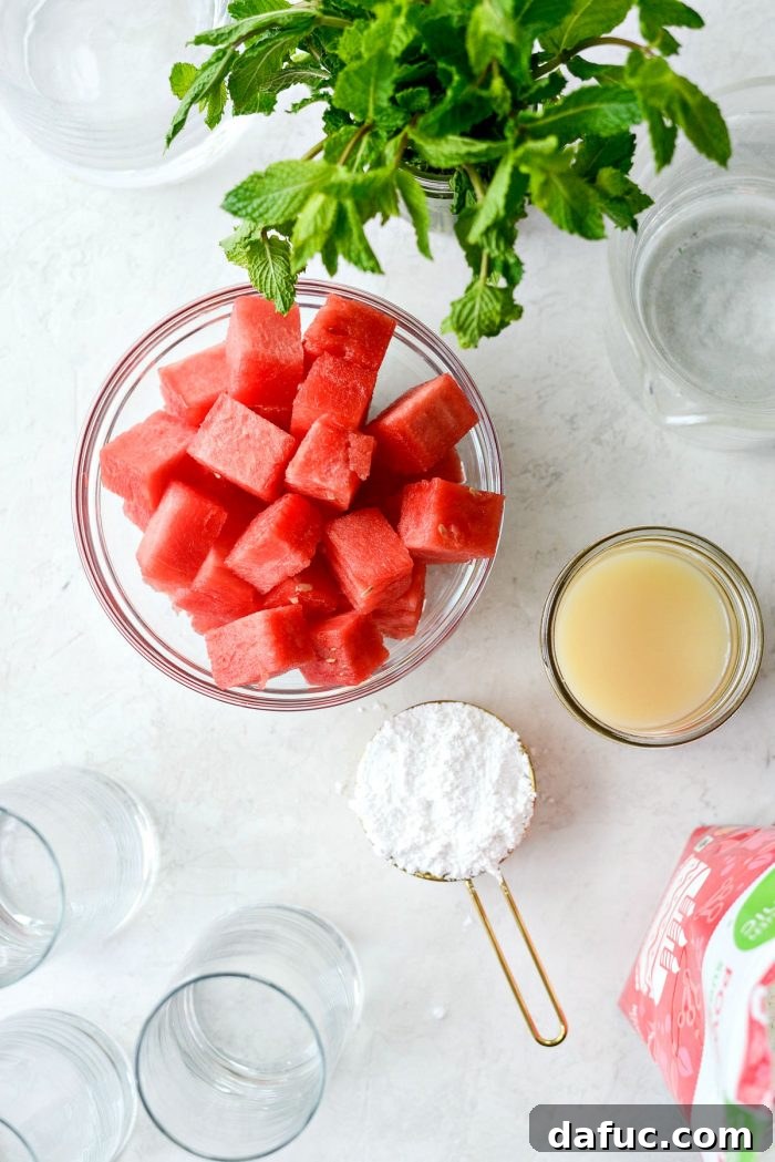 A selection of fresh ingredients for watermelon lemonade including cubed watermelon, whole lemons, a bag of powdered sugar, and a pitcher of water.
