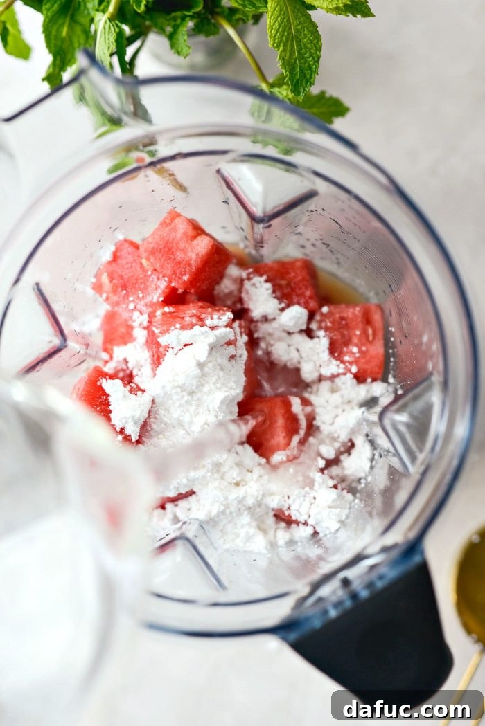 Adding powdered sugar and cold water to the blender with watermelon and lemon juice.