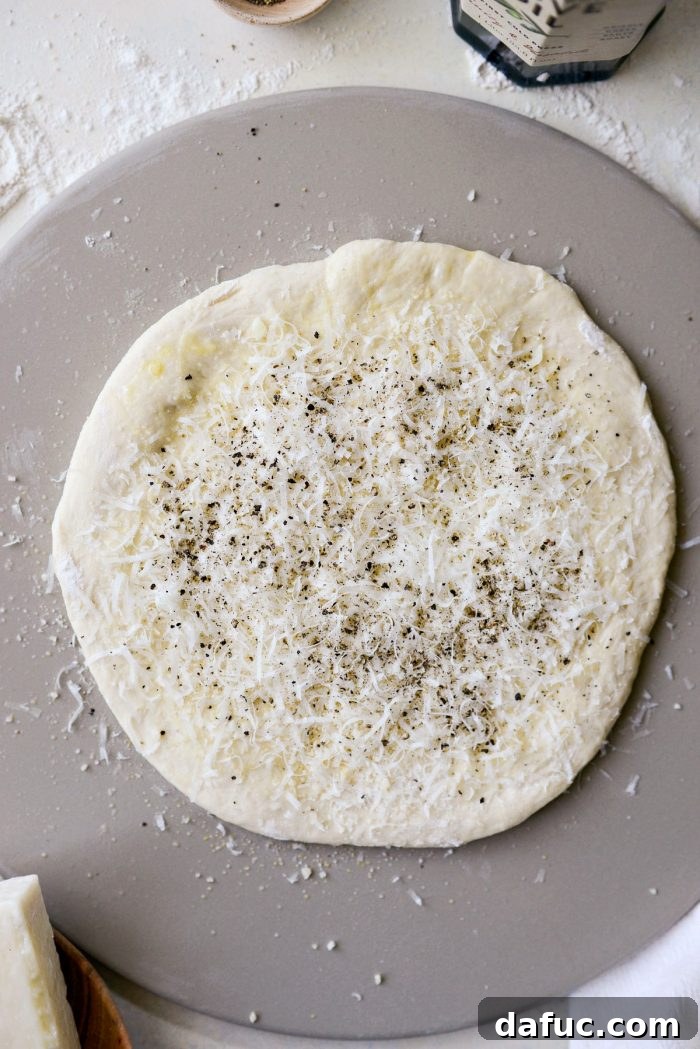 Roman Cheese and Pepper Pizza 11 Parmesan and Pecorino Romano cheeses and black pepper sprinkled on pizza dough
