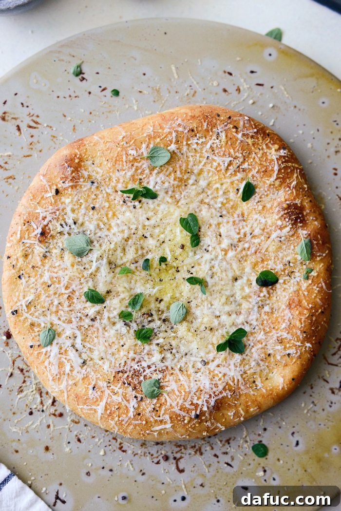 Roman Cheese and Pepper Pizza 13 Baked pizza with additional cheese, olive oil, black pepper, and fresh oregano added after baking