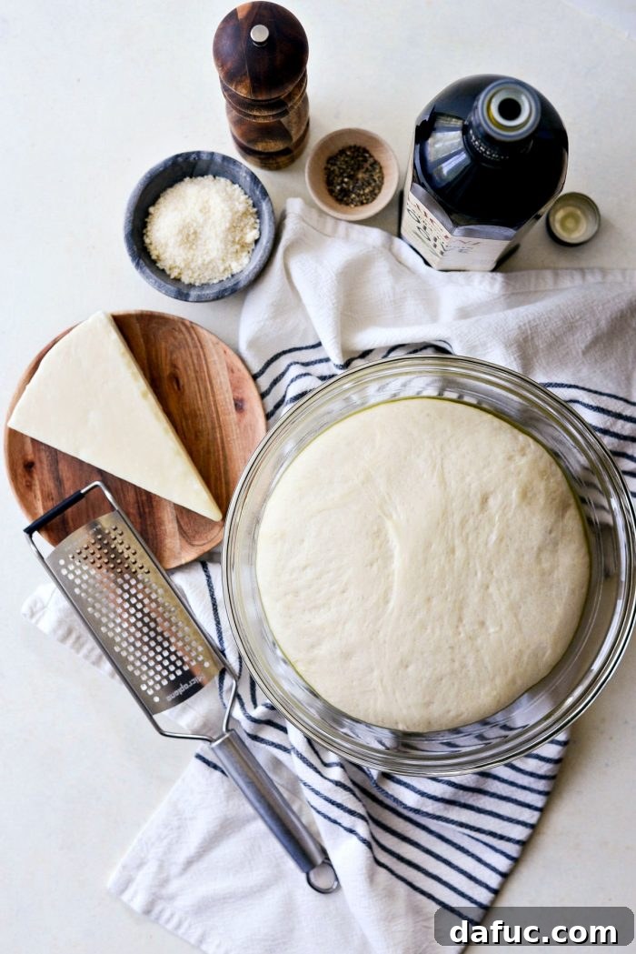 Roman Cheese and Pepper Pizza 4 Ingredients for Cacio e Pepe pizza laid out: olive oil, Pecorino Romano, Parmesan, and black pepper