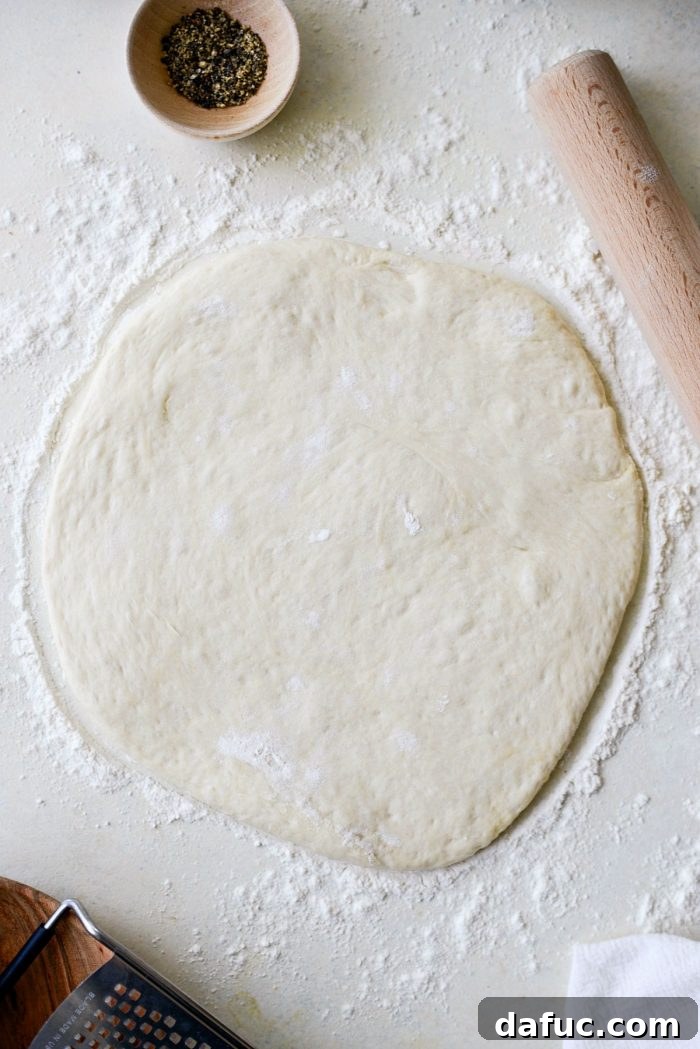 Roman Cheese and Pepper Pizza 8 Pizza dough rolled out into a circular shape, ready for toppings