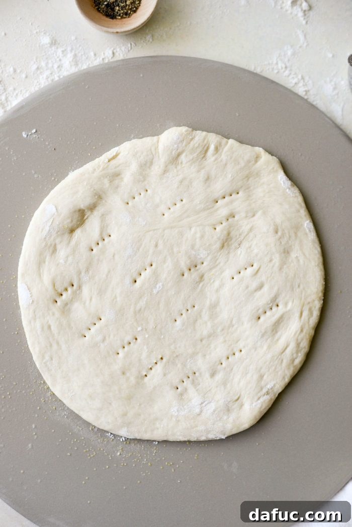 Roman Cheese and Pepper Pizza 9 Pizza dough pricked with a fork in the center to prevent bubbling