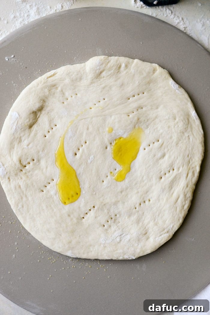 Roman Cheese and Pepper Pizza 10 Olive oil brushed onto pizza dough, creating a base for the toppings