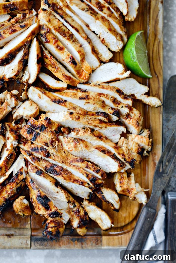 Signature Chipotle Chicken Marinade 13 A beautifully presented platter of chipotle chicken, featuring various accompaniments like a fresh salsa, indicating its versatility for meals like tacos, bowls, or salads.