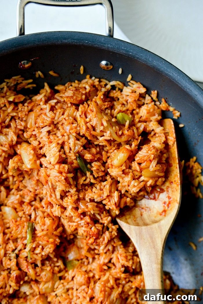 Ultimate Kimchi Fried Rice 15 Close-up of fluffy and flavorful kimchi fried rice, ready to be dished out.
