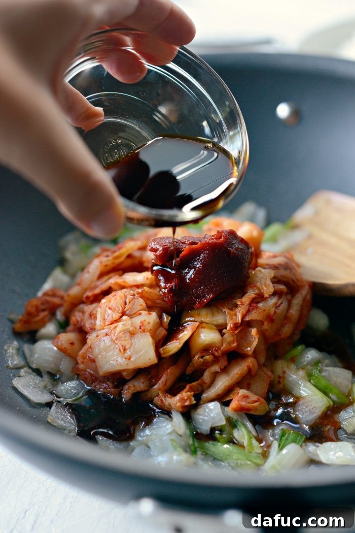 Ultimate Kimchi Fried Rice 10 Soy sauce, toasted sesame oil, white pepper, and gochujang paste added to the wok with kimchi and vegetables.