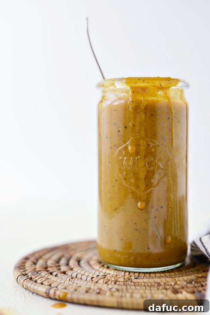 Carolina Mustard BBQ Sauce in a jar with pulled pork