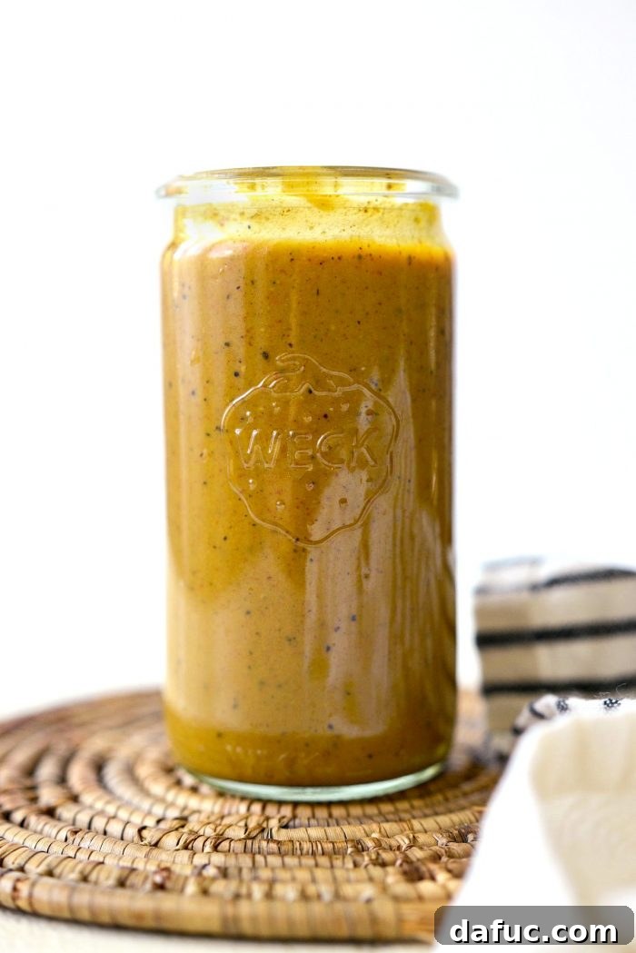 Several glass jars filled with homemade Carolina Mustard BBQ Sauce, ready for storage or use.