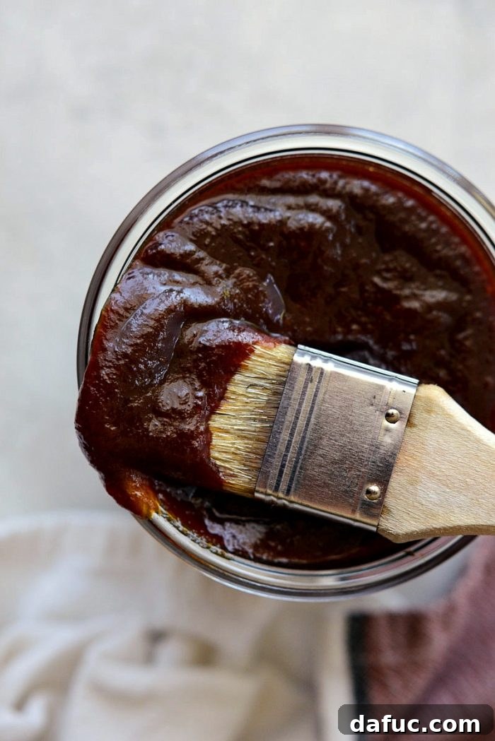 Coca-Cola Habanero BBQ Sauce glistening on grilled meat, showcasing its thick, rich texture.