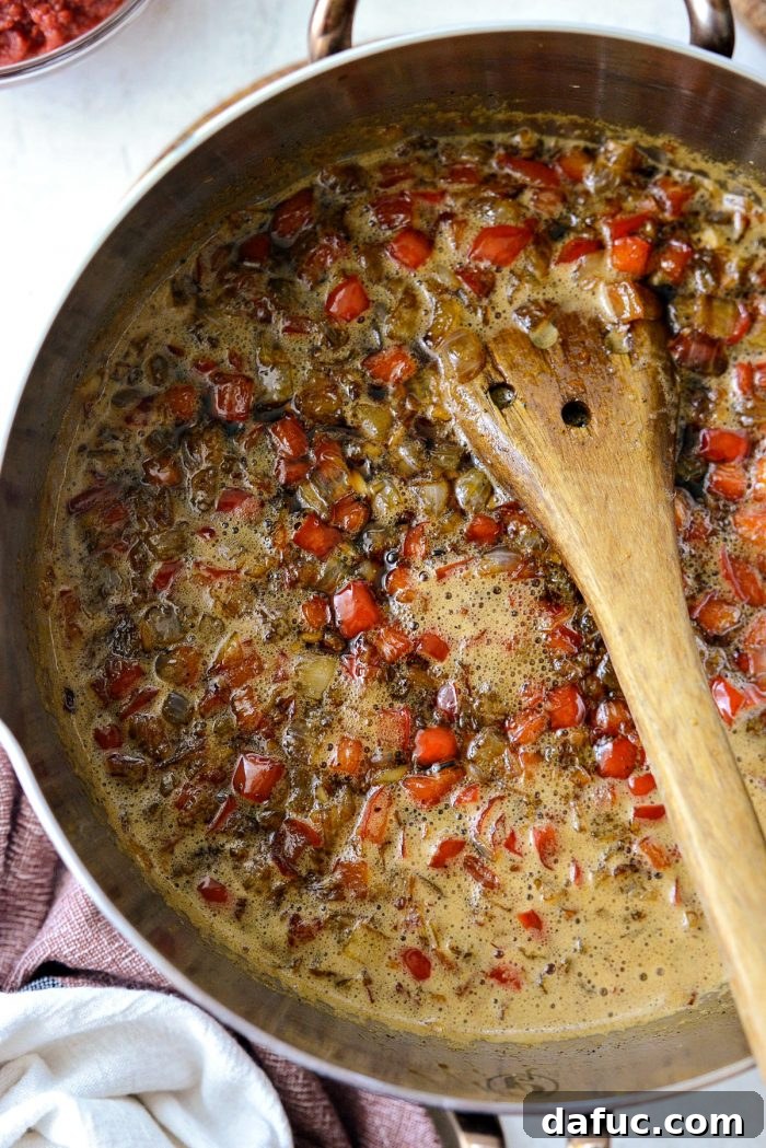 The Coca-Cola Habanero BBQ Sauce continuing to cook, thickening as it simmers.