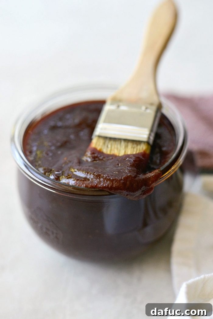 A close-up of the finished Coca-Cola Habanero BBQ Sauce in a bowl, showing its deep reddish-brown color and inviting texture.