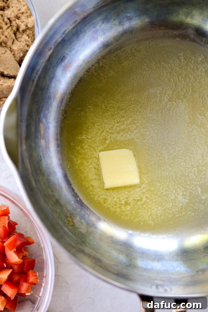 Unsalted butter melting in a large sauce pan, ready for the aromatics.