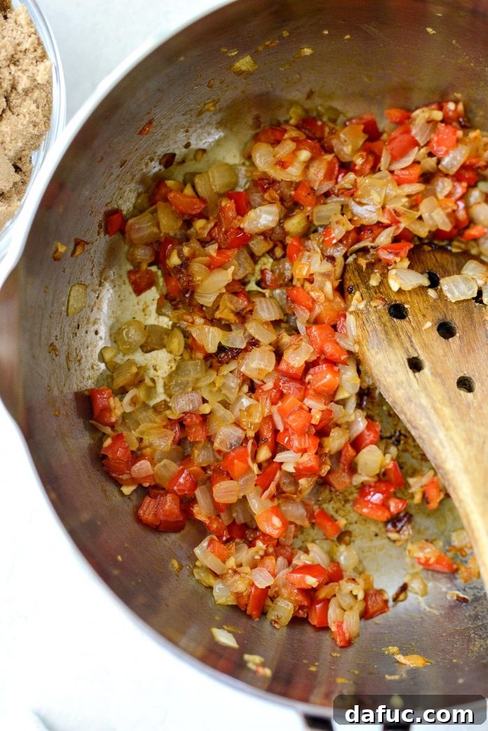 Sautéed vegetables in the pan, softened and slightly caramelized, releasing their fragrant aromas.