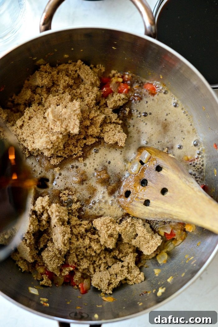 Dark brown sugar and Coca-Cola being added to the sautéed vegetables in the sauce pan.