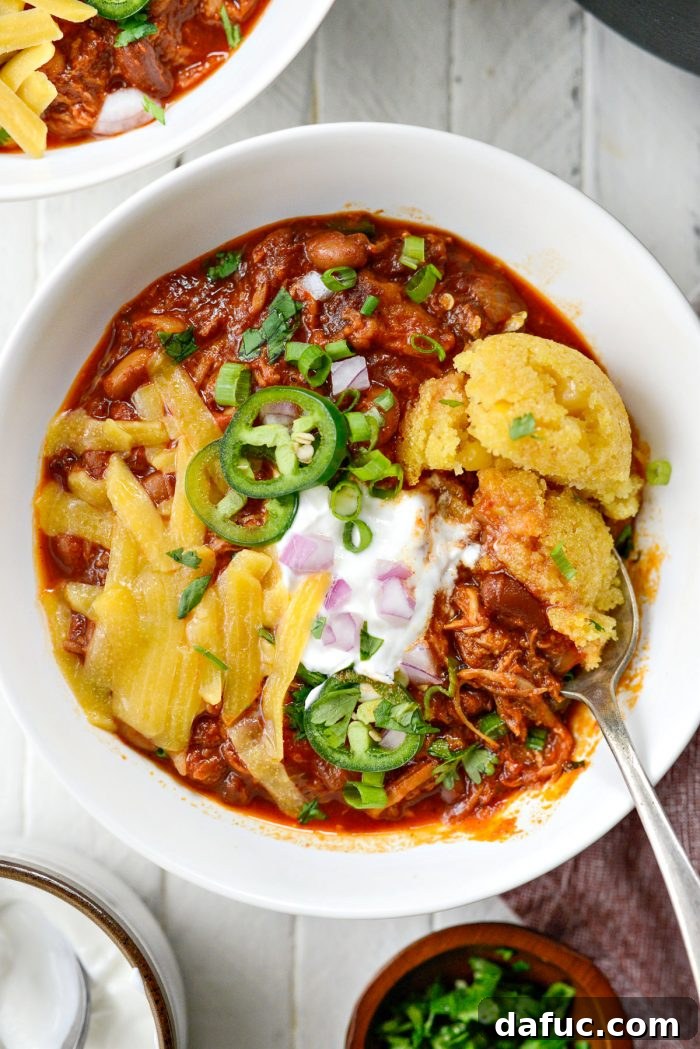 Fireside Smoky Pulled Pork Chili 16 A beautifully presented bowl of Smoky Pulled Pork Chili with a side of sweet corn cake